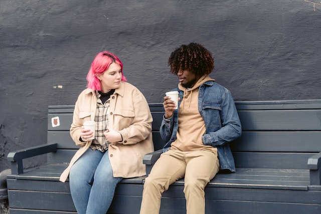 Photo by John Diez : https://www.pexels.com/photo/friends-sitting-on-a-bench-while-drinking-coffee-7388870/